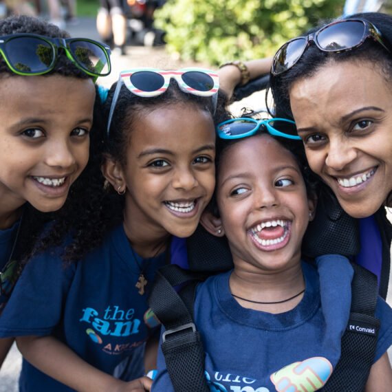 A joyful family smiling together at an A ADVANCED CAREER PLANET PTYAgain adventure event.